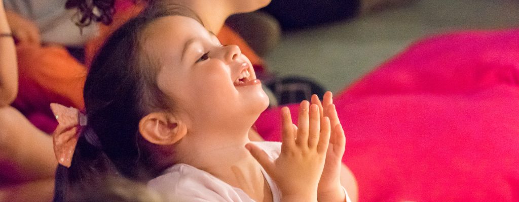 A child reacts to Puzzle Theatre's performance of Little Yarn Stories at Kinderfest 2017.