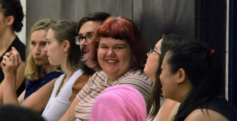 Image of Author Jessie Goyette sitting with several othe rpeople smiling at the camera