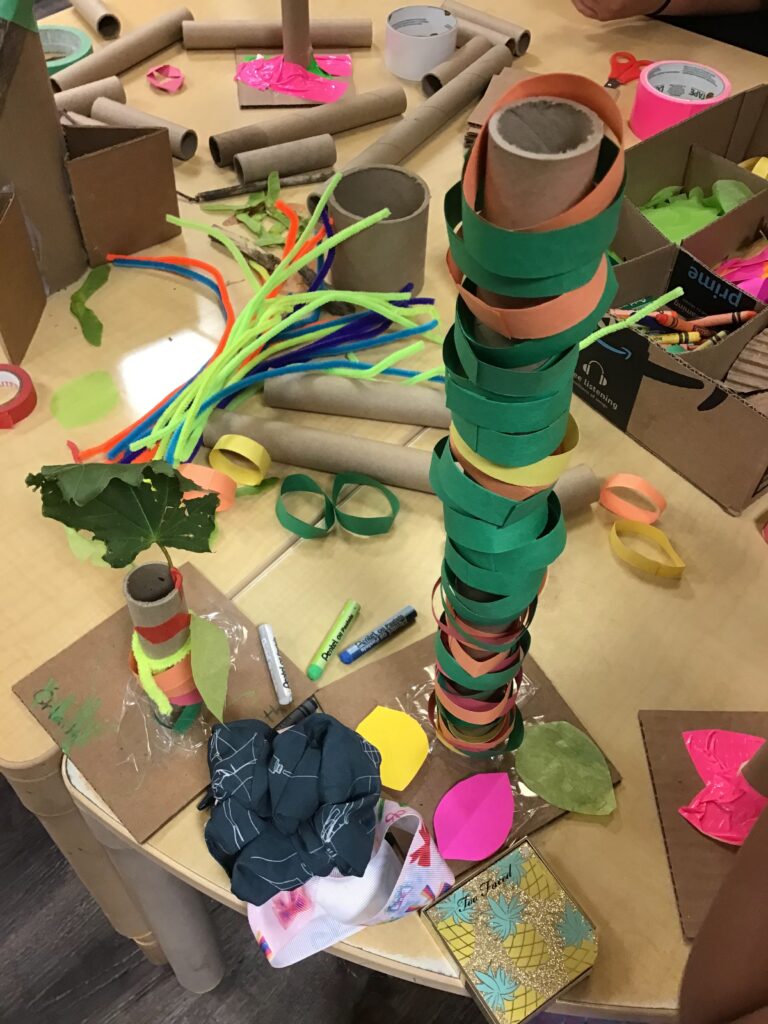 A child's tree made of a cardboard tube and multicolour rings made of construction paper