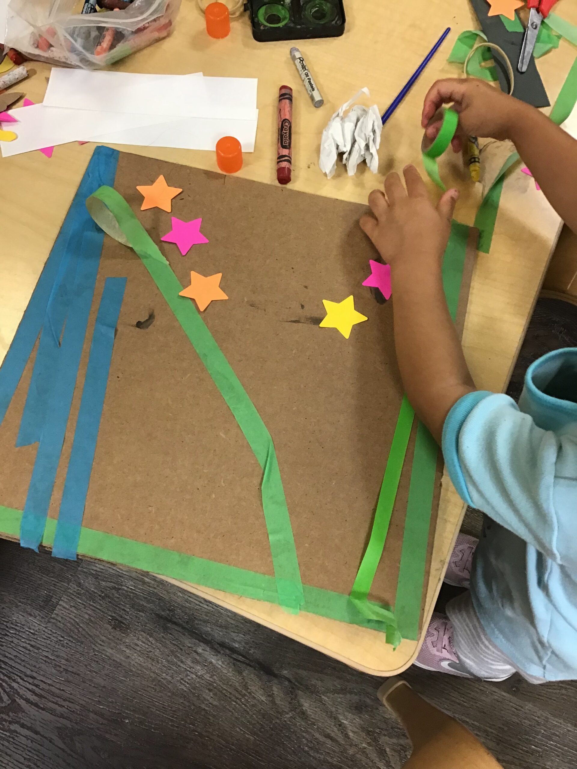 Child decorating shield made out of cardboard